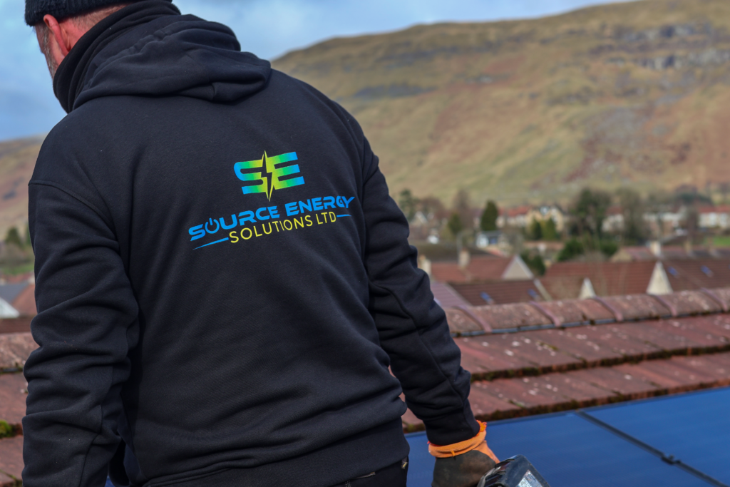 man installing solar panels on a roof