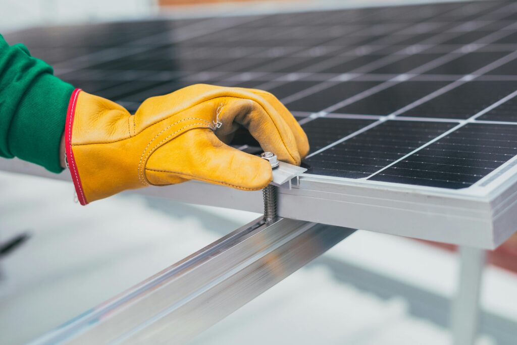 a hand installing a solar panel